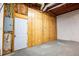 An unfinished basement has a wood paneled wall, exposed wiring, and a concrete floor at 940 Highview Se Dr, Smyrna, GA 30082