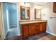 A bathroom features a dual sink vanity with granite countertops, dark wood cabinets and tile floors at 940 Highview Se Dr, Smyrna, GA 30082