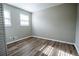 A bedroom with updated flooring, two windows providing natural light, and neutral colored walls at 940 Highview Se Dr, Smyrna, GA 30082