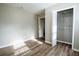 A neutral bedroom features wood-look flooring and closet with shelving for organized storage at 940 Highview Se Dr, Smyrna, GA 30082