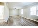 A spacious bedroom features updated flooring, two windows providing natural light, and white painted trim at 940 Highview Se Dr, Smyrna, GA 30082