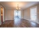Inviting dining area with wood-look flooring, updated lighting, and easy access to sunroom at 940 Highview Se Dr, Smyrna, GA 30082