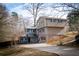 Inviting two-story home with a two-car garage and mature trees in the front yard and on a paved driveway at 940 Highview Se Dr, Smyrna, GA 30082