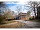 Charming two-story home with a well-manicured lawn, mature trees, and a driveway leading to the garage at 940 Highview Se Dr, Smyrna, GA 30082
