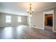 Spacious living room with wood floors, neutral walls, updated lighting, and easy access to the kitchen at 940 Highview Se Dr, Smyrna, GA 30082