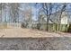 Fenced backyard with leaves covering the ground at 1059 Swaying Pines Trce, Marietta, GA 30066