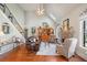 Spacious living room with a soaring ceiling, stone fireplace, hardwood floors, and staircase at 2131 Independence Ln, Buford, GA 30519