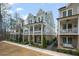 Stylish townhomes featuring lovely double porches and well-maintained landscaping and stone accents at 1004 Baldwin Dr, Milton, GA 30009