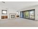 Spacious living room with a fireplace, built-in shelving and sliding glass doors at 2369 Drew Valley Ne Rd, Atlanta, GA 30319