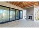 Covered patio featuring a brick fireplace and sliding glass doors to the interior at 2369 Drew Valley Ne Rd, Atlanta, GA 30319