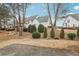 Backyard featuring manicured green shrubbery and mulched landscaping at 2414 Clock Face Ct, Lawrenceville, GA 30043