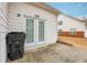 Backyard with white vinyl siding, French doors, and trash receptacle at 2414 Clock Face Ct, Lawrenceville, GA 30043