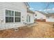 White vinyl siding with brick accents and view of backyard at 2414 Clock Face Ct, Lawrenceville, GA 30043