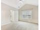 Bedroom with vaulted ceiling and doorway leading to balcony at 2414 Clock Face Ct, Lawrenceville, GA 30043