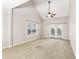 Bedroom with vaulted ceiling, carpeted floor, and a large window at 2414 Clock Face Ct, Lawrenceville, GA 30043
