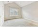 Bedroom features vaulted ceiling and carpeted floors at 2414 Clock Face Ct, Lawrenceville, GA 30043