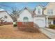 Home with attached garage, manicured bushes, and a driveway leading to the entrance at 2414 Clock Face Ct, Lawrenceville, GA 30043