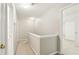Second story neutral toned carpeted hallway with white trim at 2414 Clock Face Ct, Lawrenceville, GA 30043