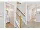 Hallway features carpeted stairs with wooden handrail at 2414 Clock Face Ct, Lawrenceville, GA 30043