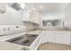 Well-lit kitchen features white cabinets, modern appliances, and an open layout at 2414 Clock Face Ct, Lawrenceville, GA 30043