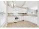 Kitchen boasts bright white cabinets, ample counter space, and a modern oven at 2414 Clock Face Ct, Lawrenceville, GA 30043