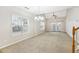Spacious living room filled with natural light, ceiling fan, and access to the back patio at 2414 Clock Face Ct, Lawrenceville, GA 30043