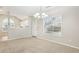 Living room featuring modern lighting fixture, with view of kitchen and front door at 2414 Clock Face Ct, Lawrenceville, GA 30043