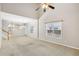 Living room area features a ceiling fan and multiple windows for natural light at 2414 Clock Face Ct, Lawrenceville, GA 30043
