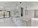 Spacious white kitchen featuring stainless steel appliances, a large island, and modern lighting at 4234 Hamilton Mill Rd, Buford, GA 30519