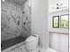 This bathroom features a glass walk-in shower with marble tiling and a sleek, modern toilet at 4238 Hamilton Mill Rd, Buford, GA 30519