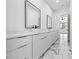 This bathroom features a double vanity, marble floors, white cabinets, and modern fixtures at 4238 Hamilton Mill Rd, Buford, GA 30519