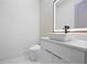 Modern half bath features a sleek vanity, designer lighting, and stylish finishes at 4238 Hamilton Mill Rd, Buford, GA 30519