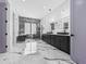 Luxurious bathroom featuring marble floors, dual vanities, stylish lighting, and a modern bathtub at 4238 Hamilton Mill Rd, Buford, GA 30519