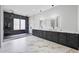Luxurious bathroom featuring double showers, a large illuminated mirror, dual sinks, and elegant marble flooring at 4238 Hamilton Mill Rd, Buford, GA 30519