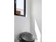 Sleek black toilet with integrated bidet features, set against a clean, minimalist white wall at 4238 Hamilton Mill Rd, Buford, GA 30519