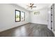 This airy bedroom features hardwood floors, white walls, a modern ceiling fan, and great natural light at 4238 Hamilton Mill Rd, Buford, GA 30519