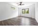 Bright bedroom featuring hardwood floors, white walls, modern ceiling fan, and natural light from dual windows at 4238 Hamilton Mill Rd, Buford, GA 30519