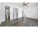 A bedroom features hardwood floors, white walls, a modern ceiling fan, and multiple entryways at 4238 Hamilton Mill Rd, Buford, GA 30519
