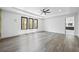 Spacious bedroom with gray hardwood floors and tray ceiling at 4238 Hamilton Mill Rd, Buford, GA 30519