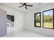 Bright bedroom with white walls, large windows, and modern ceiling fan at 4238 Hamilton Mill Rd, Buford, GA 30519