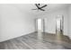 This bedroom features hardwood floors, white walls, a modern ceiling fan, and access to the bathroom at 4238 Hamilton Mill Rd, Buford, GA 30519