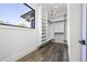 A well-organized walk-in closet with custom shelving, ample storage, and a window for natural light at 4238 Hamilton Mill Rd, Buford, GA 30519