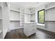 Spacious walk-in closet featuring custom shelving, drawers, and a view to the outside at 4238 Hamilton Mill Rd, Buford, GA 30519