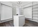 Bright walk-in closet with custom shelving and island with drawers offering lots of storage at 4238 Hamilton Mill Rd, Buford, GA 30519