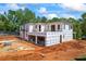 Modern home with wrap under construction, set on a spacious lot with visible framing at 4238 Hamilton Mill Rd, Buford, GA 30519
