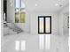 Bright entryway with marble floors, staircase, and modern glass railing, leading to a double black door and open-concept space at 4238 Hamilton Mill Rd, Buford, GA 30519