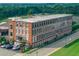 Brick Tannery Row building with large windows and adjacent street view from an aerial perspective at 4238 Hamilton Mill Rd, Buford, GA 30519