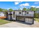 Modern home with two-car garage, balcony, and landscaping, on a well-manicured lawn at 4238 Hamilton Mill Rd, Buford, GA 30519