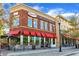Buford Grill displays a modern brick facade, complemented by red awnings and sidewalk dining at 4238 Hamilton Mill Rd, Buford, GA 30519