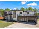 New modern home with a two-car garage and balcony on a well-manicured lawn at 4238 Hamilton Mill Rd, Buford, GA 30519